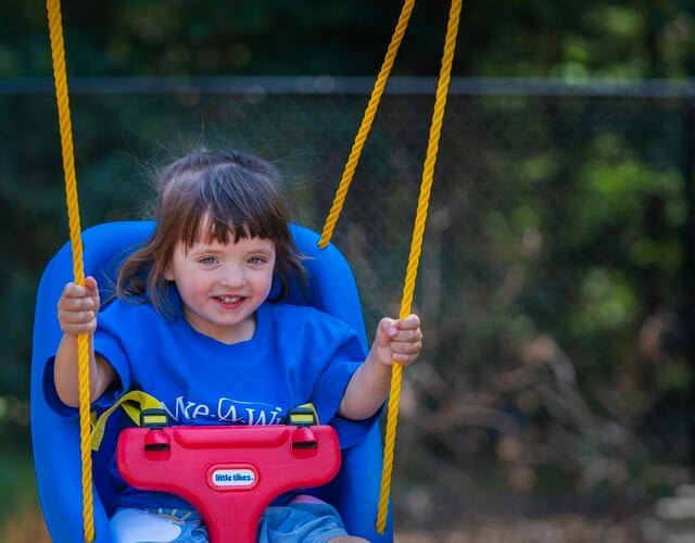 A young girl swinging on her new swing