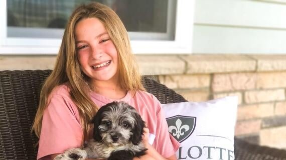 Sydney plays with her brand new puppy Milo after her wish comes true