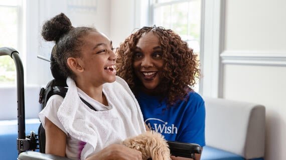 Wish kid Shayna with her maltipoo and volunteer Barbara