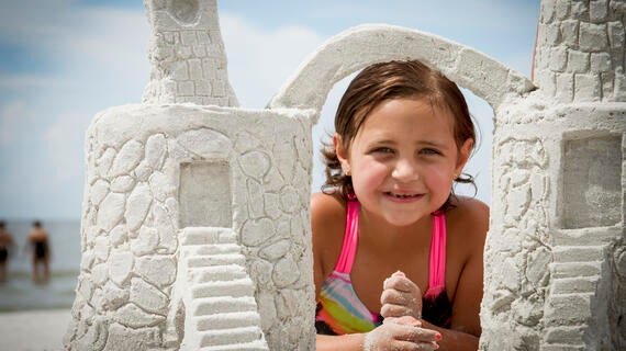 Madison with her sandcastle 