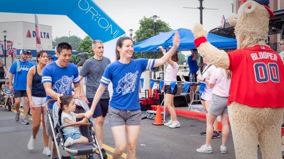 Braves mascot Blooper greets Walk for Wishes participants with a high-five at the finish line.