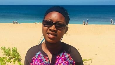 Wish Kid Malayna smiling by the beach in Hawaii.