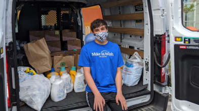 Wish kid Sam with his gift packages for healthcare workers