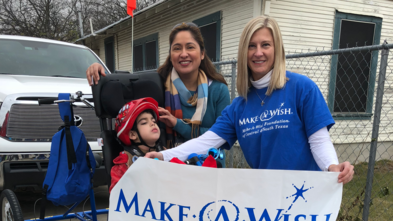 Sarah with wish kid and mom and brand new bike.