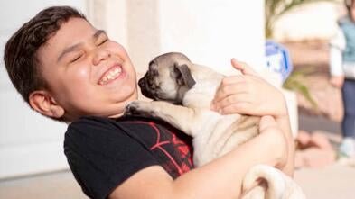 Jean could not contain his happiness meeting his pug puppy