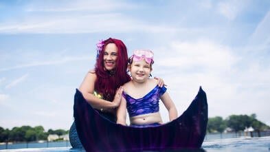 Emma posing with Mermaid Shannon outside of the pool