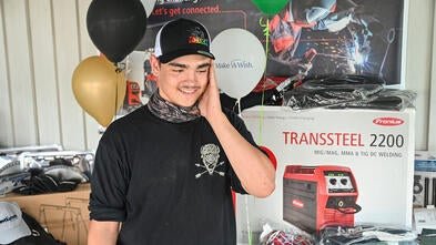 Noah looks in awe at all his new welding tools.