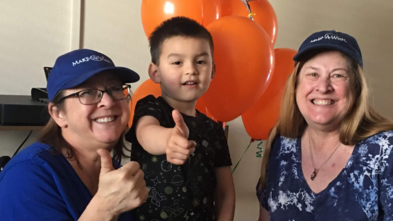 Volunteer wish granters Dana Smith and Debi Hanselman during a wish reveal