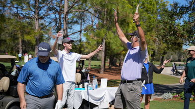 Men celebrating on the golf green at Wedges for Wishes