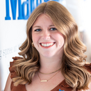 Megan Nuss, Director of Corporate Relations, in front of Wish Wall