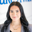 Citlalli Celis, Wish Coordinator, in front of Wish Wall