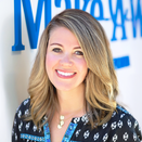 Dana Snyder, Director of Wish Delivery, in front of Wish Wall