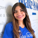 Gloria Ayala, Wish Manager, standing in front of Wish Wall