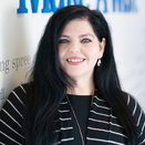 Jennifer Gonzales, Vice President of Mision Delivery, in front of Wish Wall