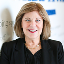 Jodi Stoken, Chief Development Officer, standing in front of Wish Wall