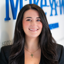 Juliana Rengifo, Wish Manager, standing in front of Wish Wall