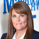 Cindy Mero, Senior Director of Philanthropy, in front of Wish Wall