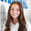 Halah Berglin, Events Specialist, in front of Wish Wall