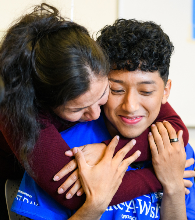 Henry and his mom hug on his wish day